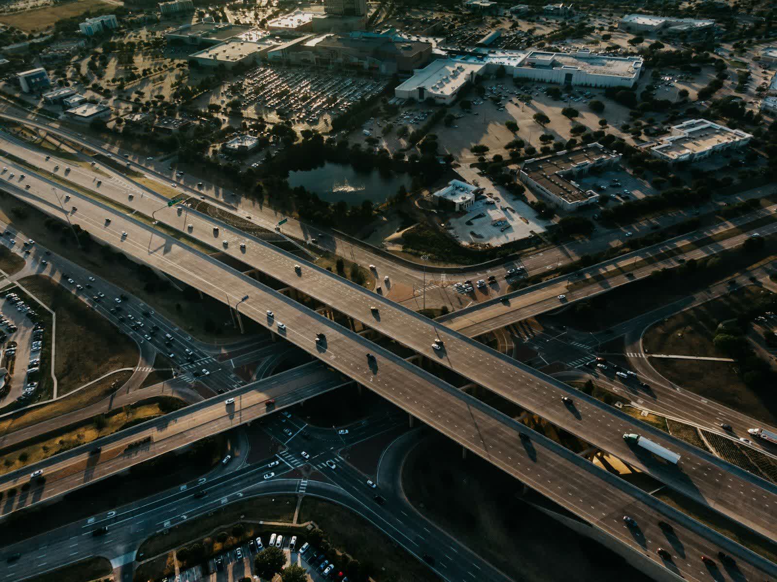 An aerial view of a freeway interchange crossing over surface streets