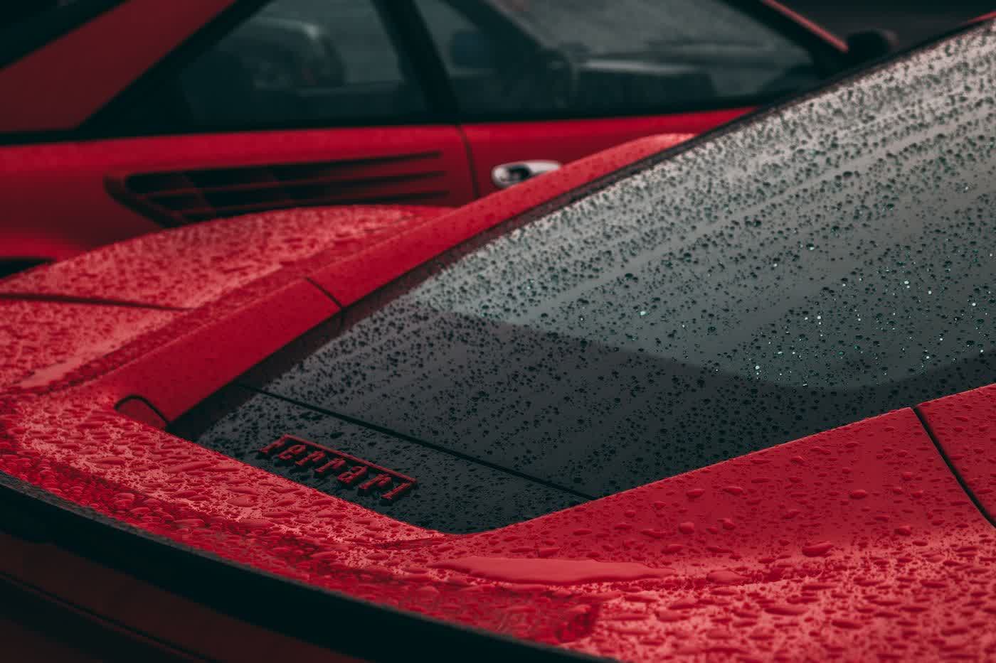 Water standing in tight beads across a coated hood and windshield