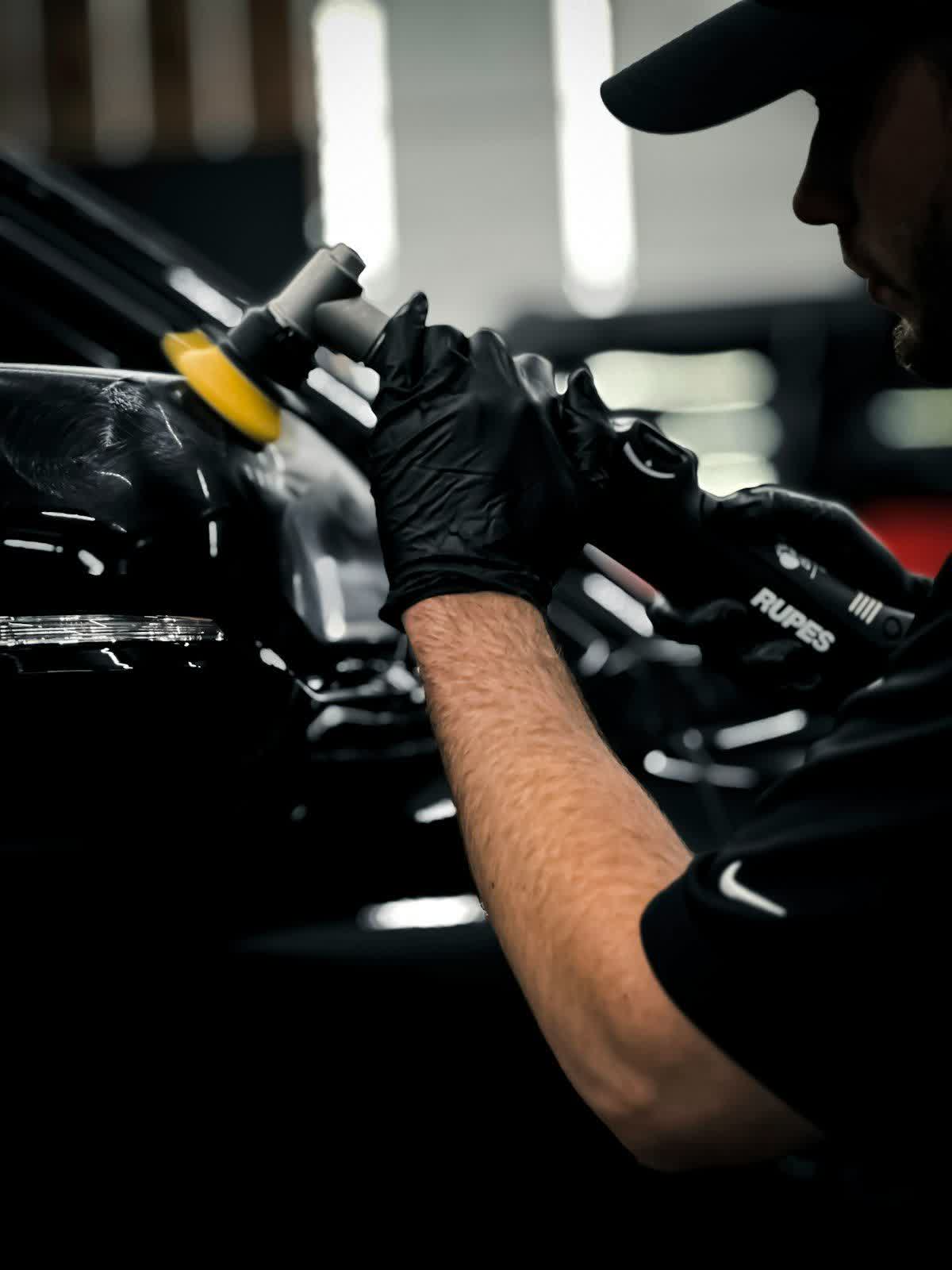 Paint being hand-finished along a panel edge